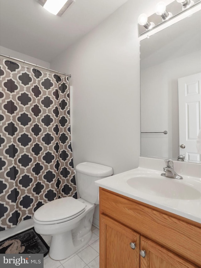 bathroom featuring toilet, vanity, and tile patterned floors