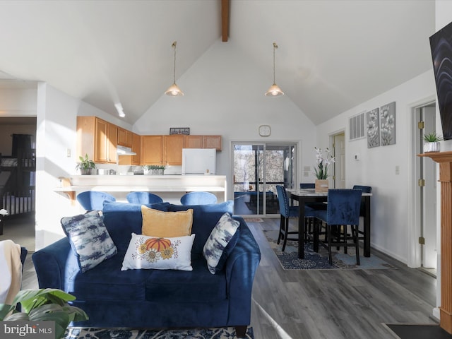 living room with beamed ceiling, dark hardwood / wood-style flooring, and high vaulted ceiling