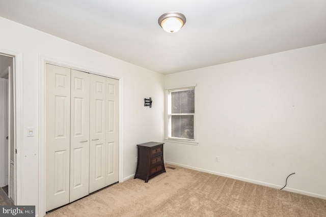 carpeted bedroom featuring a closet