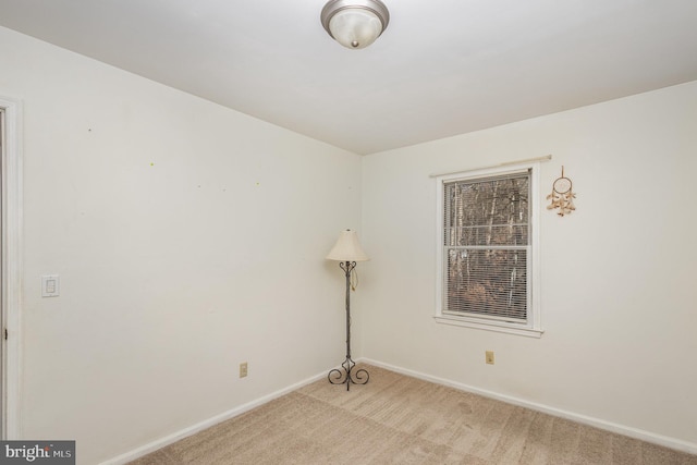 spare room featuring light colored carpet