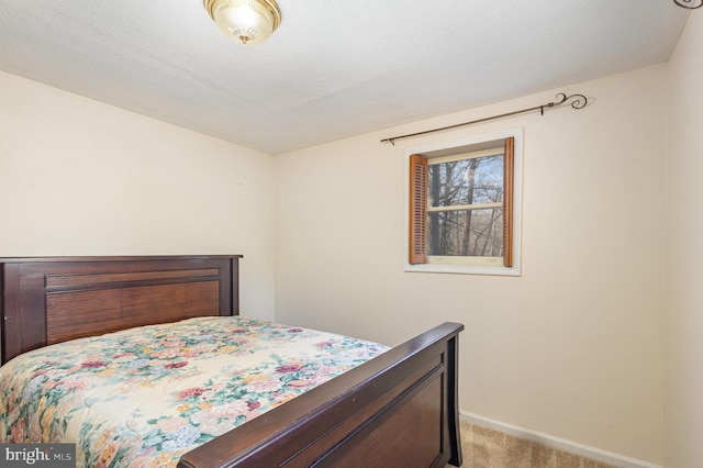 bedroom with a textured ceiling and light carpet