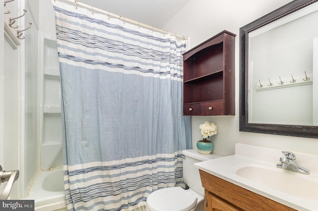 full bathroom featuring vanity, shower / bath combination with curtain, and toilet