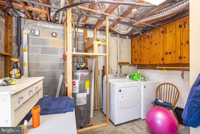 washroom with water heater and washer and dryer