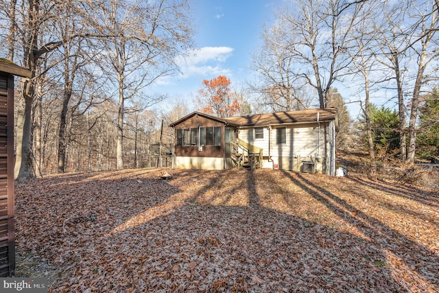 exterior space featuring central air condition unit and a sunroom