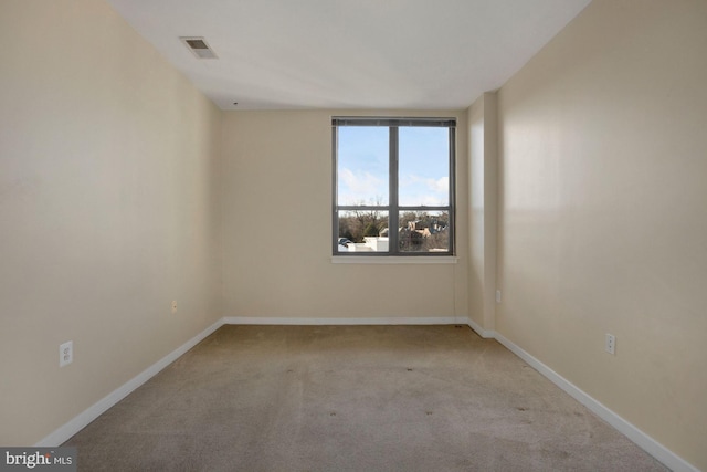 empty room featuring light colored carpet