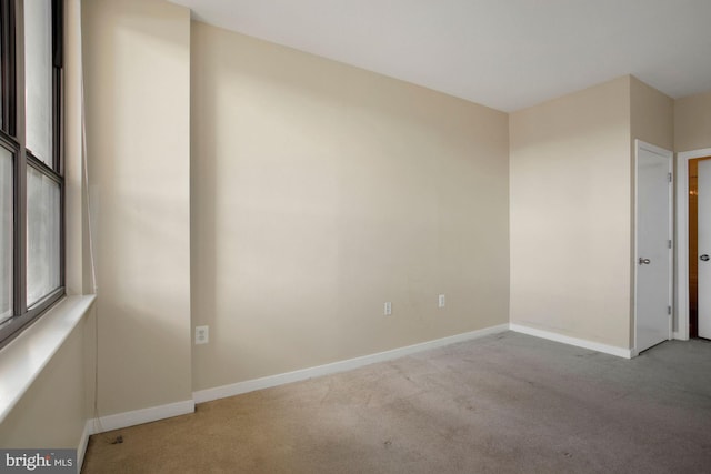 spare room with light colored carpet