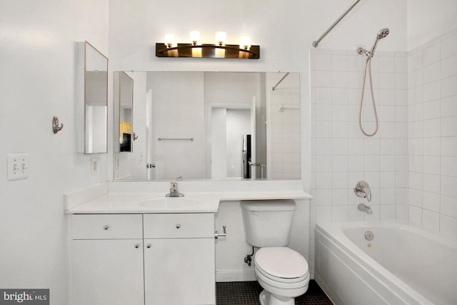 full bathroom with tile patterned floors, tiled shower / bath combo, toilet, and vanity