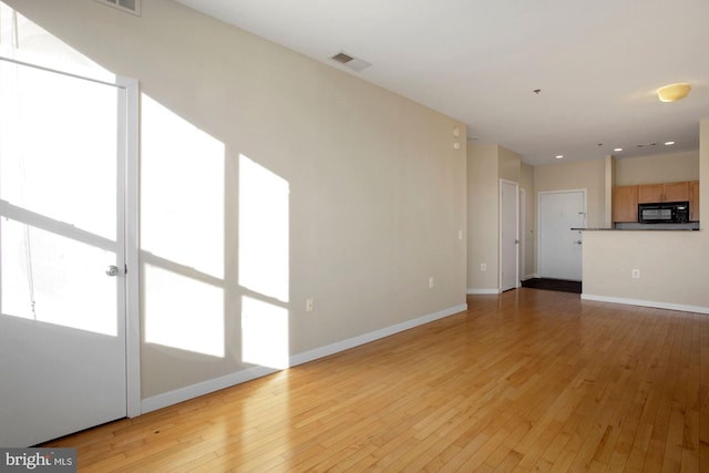 unfurnished living room featuring light wood-type flooring