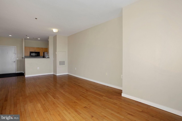 unfurnished living room with light wood-type flooring