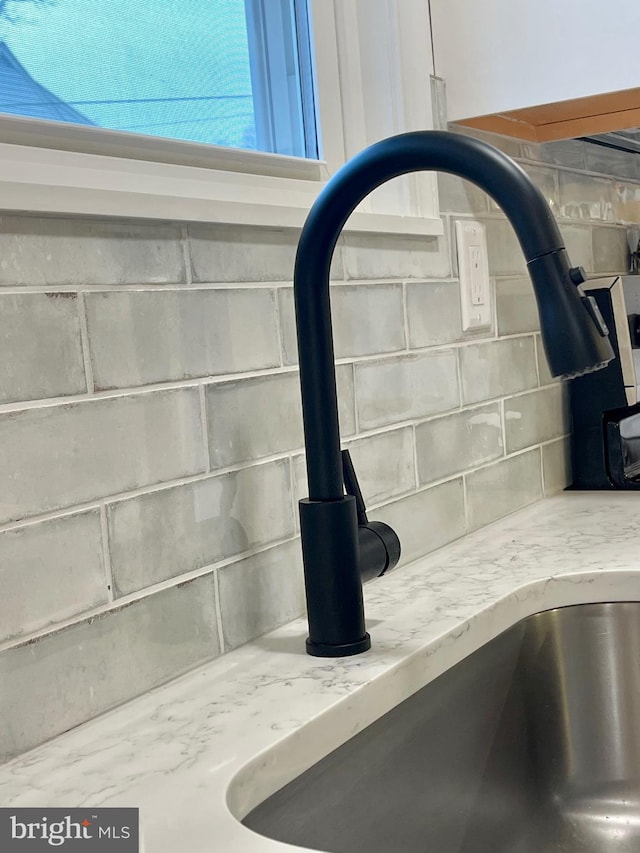 details featuring light stone countertops