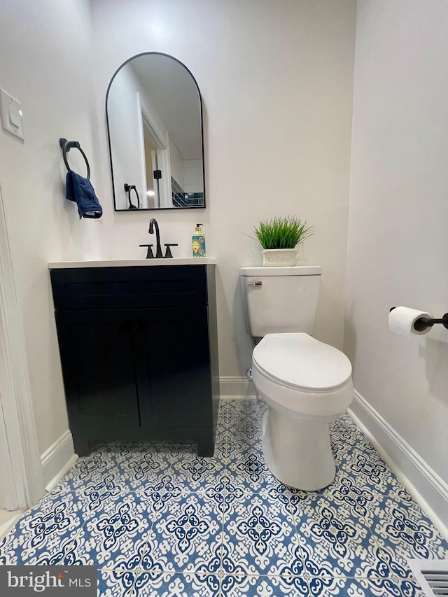 bathroom featuring vanity and toilet