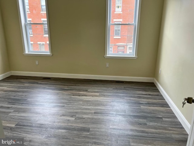 unfurnished room with dark hardwood / wood-style floors