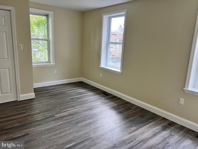 unfurnished room with dark hardwood / wood-style floors