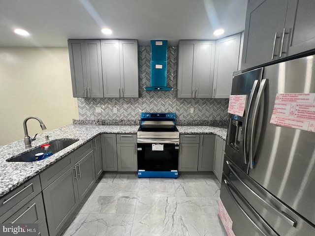 kitchen featuring gray cabinetry, sink, wall chimney exhaust hood, and stainless steel appliances