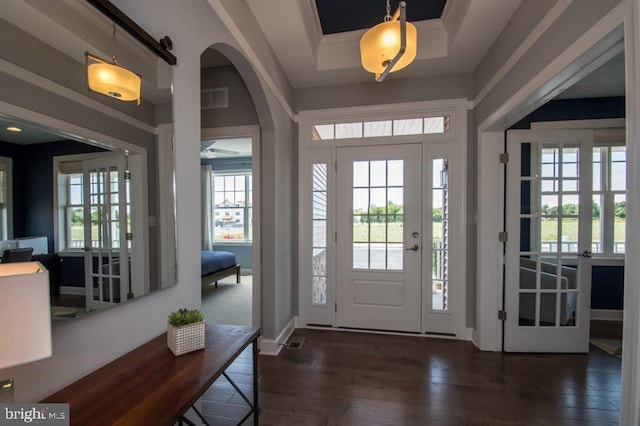 entrance foyer featuring dark hardwood / wood-style flooring, plenty of natural light, and french doors