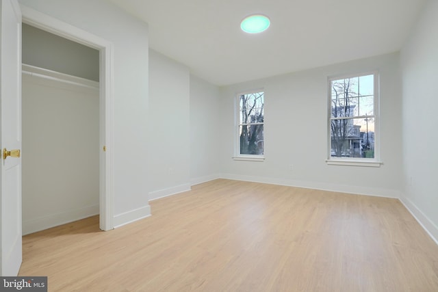 unfurnished bedroom featuring a closet and light hardwood / wood-style flooring