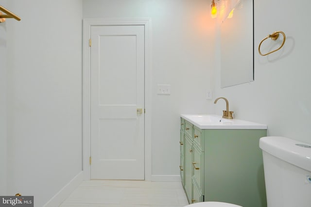 bathroom with tile patterned flooring, vanity, and toilet