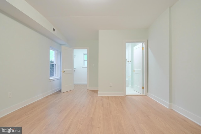 empty room with light hardwood / wood-style flooring