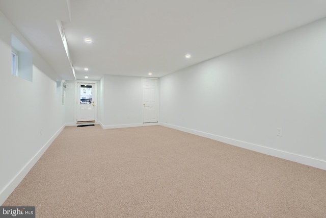 basement featuring light colored carpet