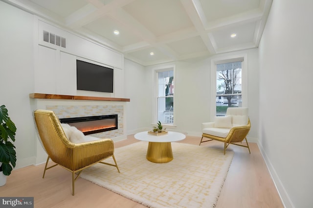 sitting room with beamed ceiling, light hardwood / wood-style floors, and coffered ceiling