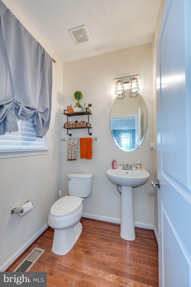 bathroom with sink, wood-type flooring, and toilet