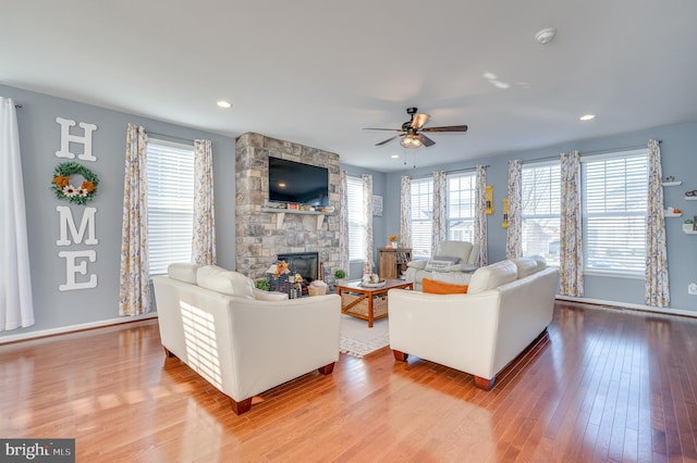 living room featuring a fireplace, ceiling fan, and hardwood / wood-style floors