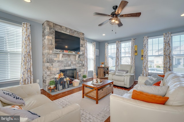 living room featuring a fireplace, ceiling fan, and hardwood / wood-style floors