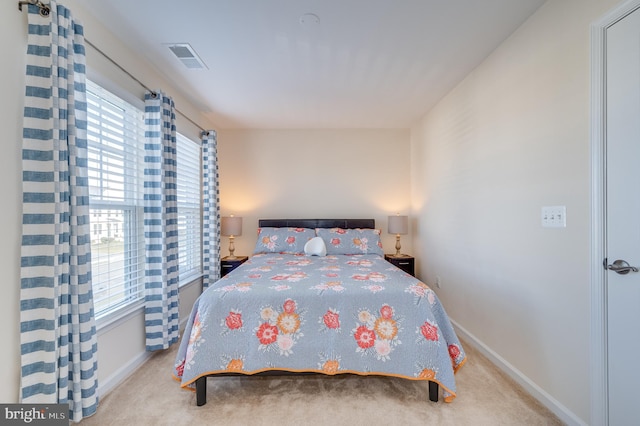 carpeted bedroom with multiple windows