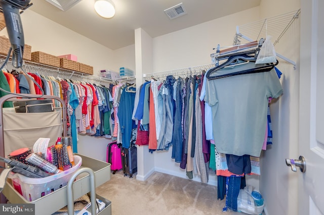 walk in closet with carpet flooring