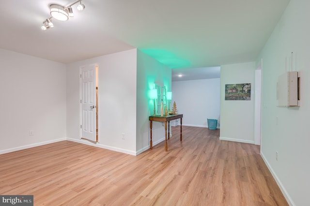 unfurnished room featuring electric panel and light wood-type flooring