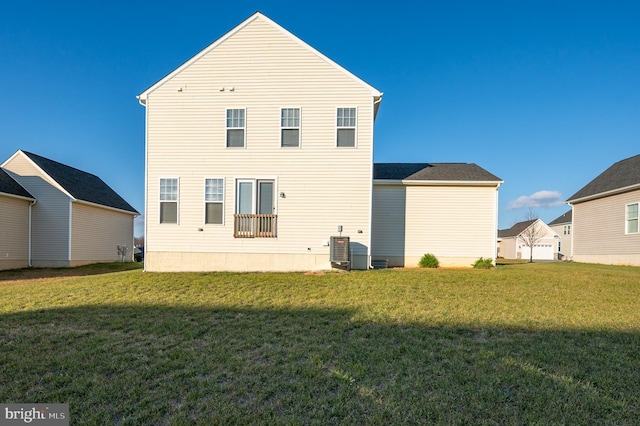 back of house featuring a yard and central air condition unit