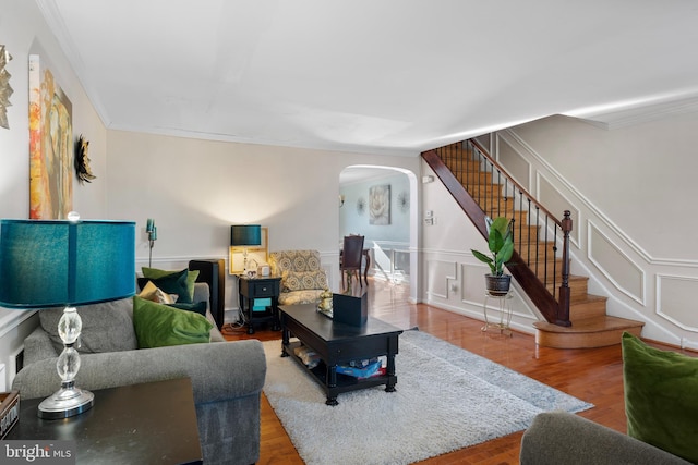 living room with wood-type flooring and ornamental molding