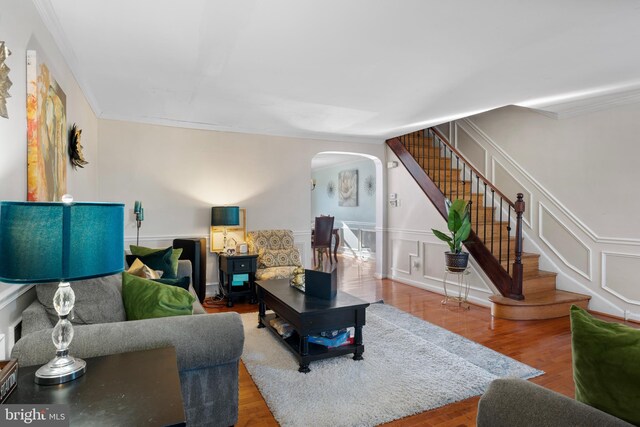 102 W Walnut Park Dr, Philadelphia, PA 19120 - living area with arched walkways, stairs, wood finished floors, and crown molding