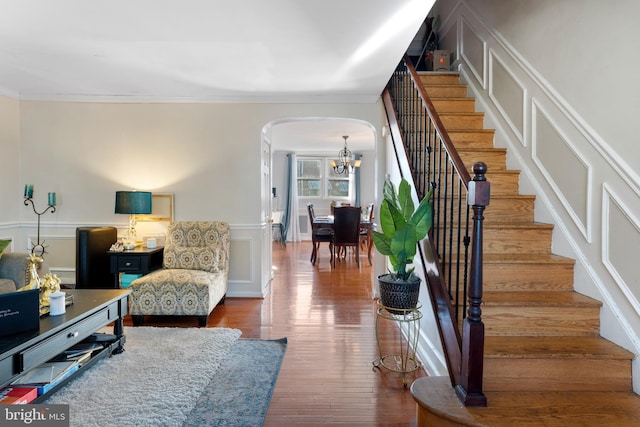 102 W Walnut Park Dr, Philadelphia, PA 19120 - living area with arched walkways, a decorative wall, stairway, crown molding, and wood finished floors