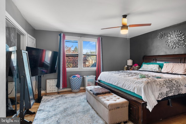 bedroom featuring ceiling fan, a closet, and light hardwood / wood-style floors