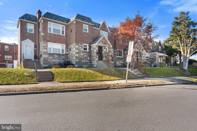 102 W Walnut Park Dr, Philadelphia, PA 19120 - view of front facade with a residential view, brick siding, a chimney, a high end roof, and mansard roof