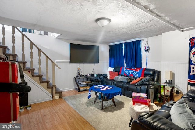 102 W Walnut Park Dr, Philadelphia, PA 19120 - living room featuring wood finished floors, wainscoting, and stairway