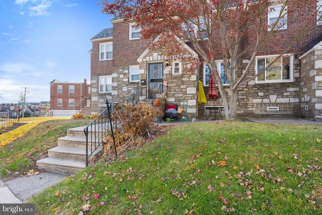 102 W Walnut Park Dr, Philadelphia, PA 19120 - townhome / multi-family property featuring stone siding, a front yard, and brick siding