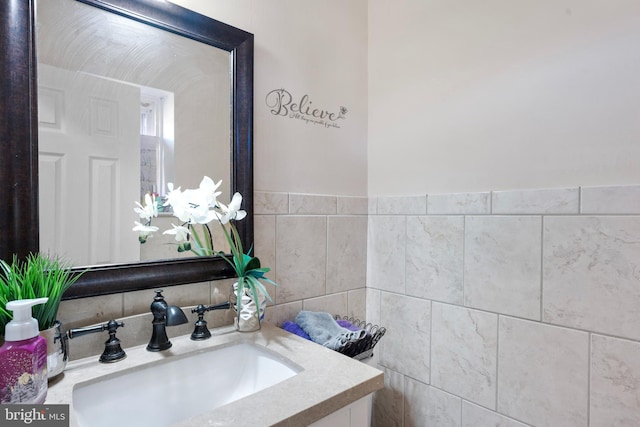 bathroom featuring vanity and tile walls