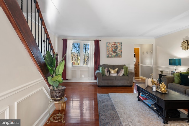 living room with dark hardwood / wood-style flooring and ornamental molding