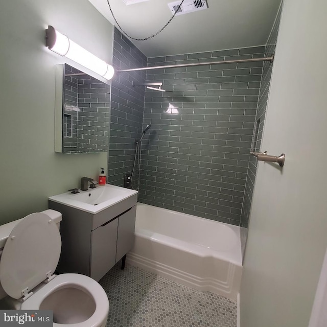 full bathroom with toilet, vanity, and tiled shower / bath