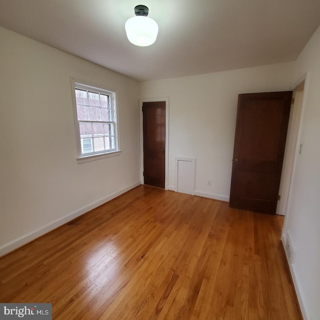 empty room with light hardwood / wood-style flooring