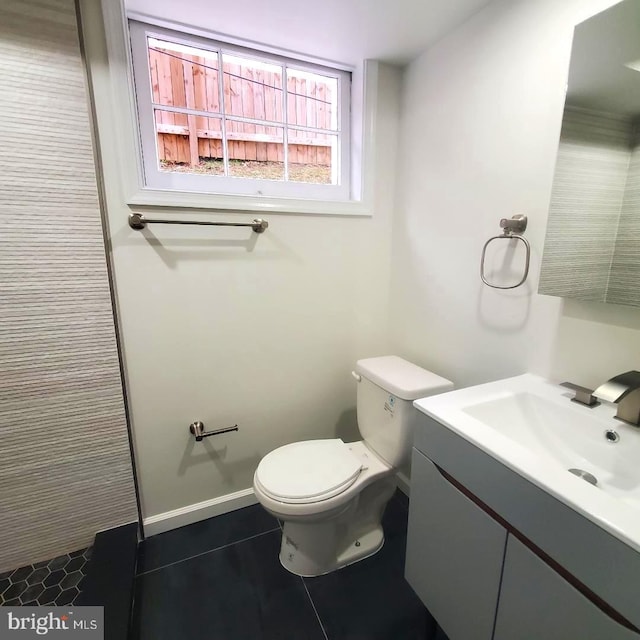 bathroom with tile patterned floors, vanity, and toilet