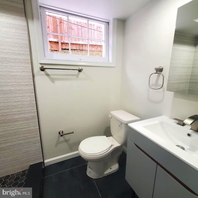 4457 Alabama Ave SE, Washington, DC 20019 - bathroom featuring toilet, vanity, and tile patterned flooring