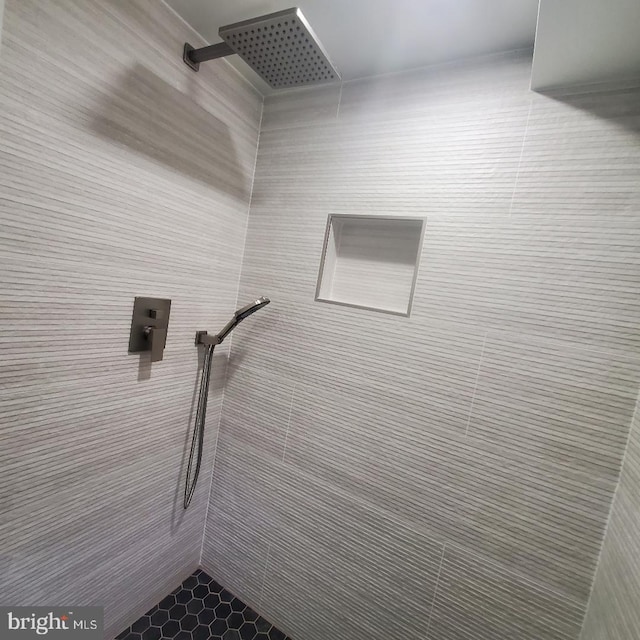 bathroom featuring walk in shower, tile patterned floors, and tile walls