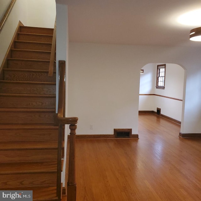 stairs featuring wood-type flooring