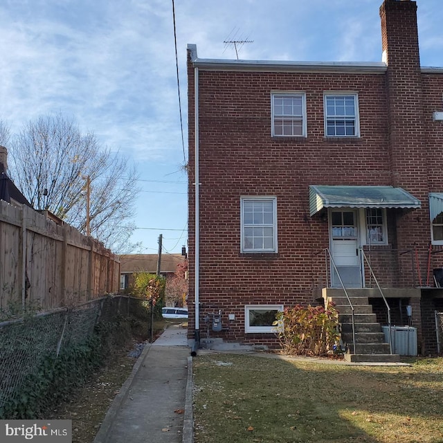 4457 Alabama Ave SE, Washington, DC 20019 - rear view of house featuring brick siding and a chimney