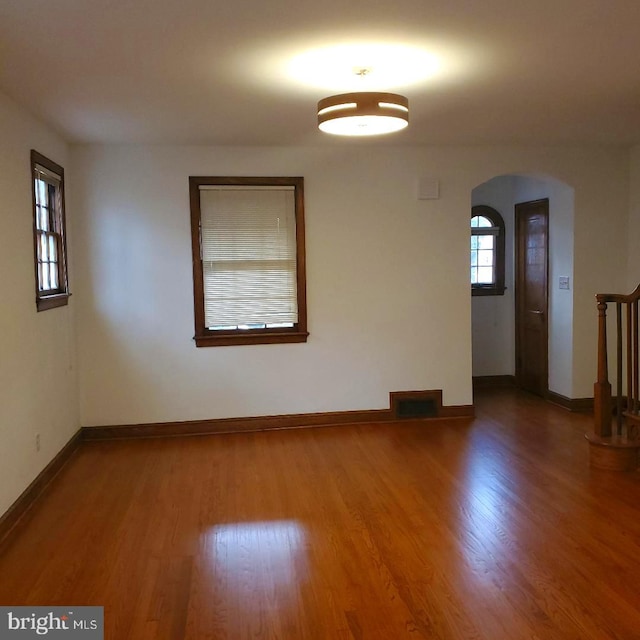 4457 Alabama Ave SE, Washington, DC 20019 - unfurnished room featuring arched walkways, wood finished floors, and baseboards