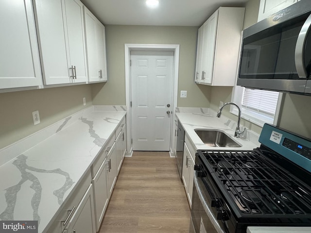 kitchen with white cabinets, sink, and stainless steel appliances