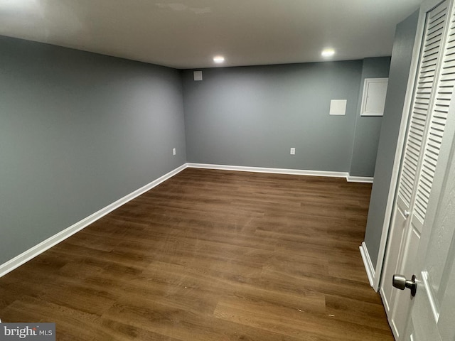 basement with dark hardwood / wood-style flooring